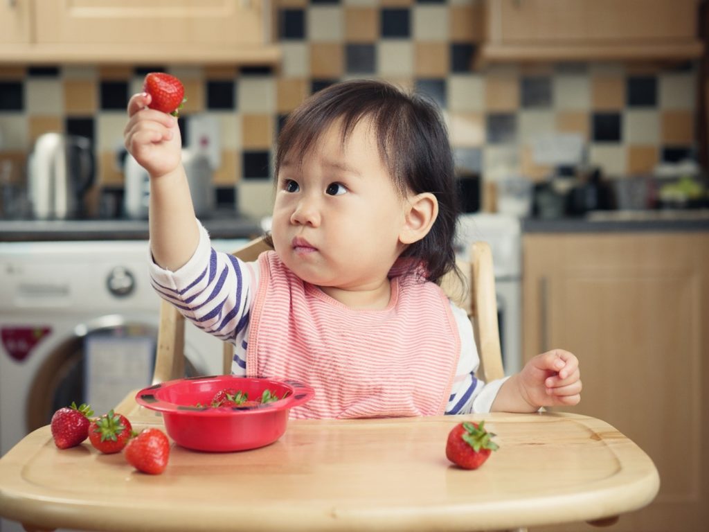 Bellamys Organic baby eating strawberries